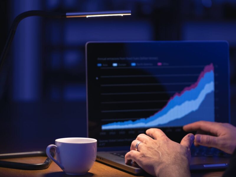 Businessman or broker looking at computer laptop analyzing about stock market invest trading stocks graph analysis. Trading online investment data price crypto currency market graph.